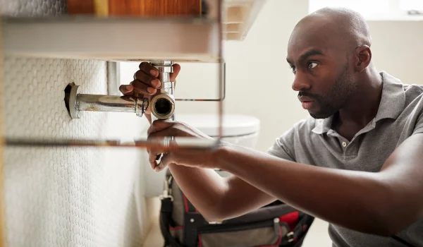 a male plumber fixing a pipe connection from quality plumbing leander in Leander, TX Plumber near me a male plumber fixing a pipe connection from quality plumbing leander in Leander, TX Plumber near me